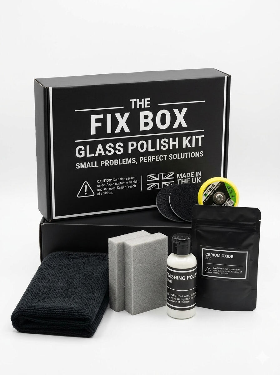 A lifestyle shot of an open kit box from The Fix Box on a damaged glass table The image showcases the contents of The Fix Box Professional Cerium Oxide Glass Polish Kit alongside a household drill to represent its use case. The Glass table shows slight scuffs and scratches